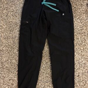 4 pairs of black scrub pants and 3 tops